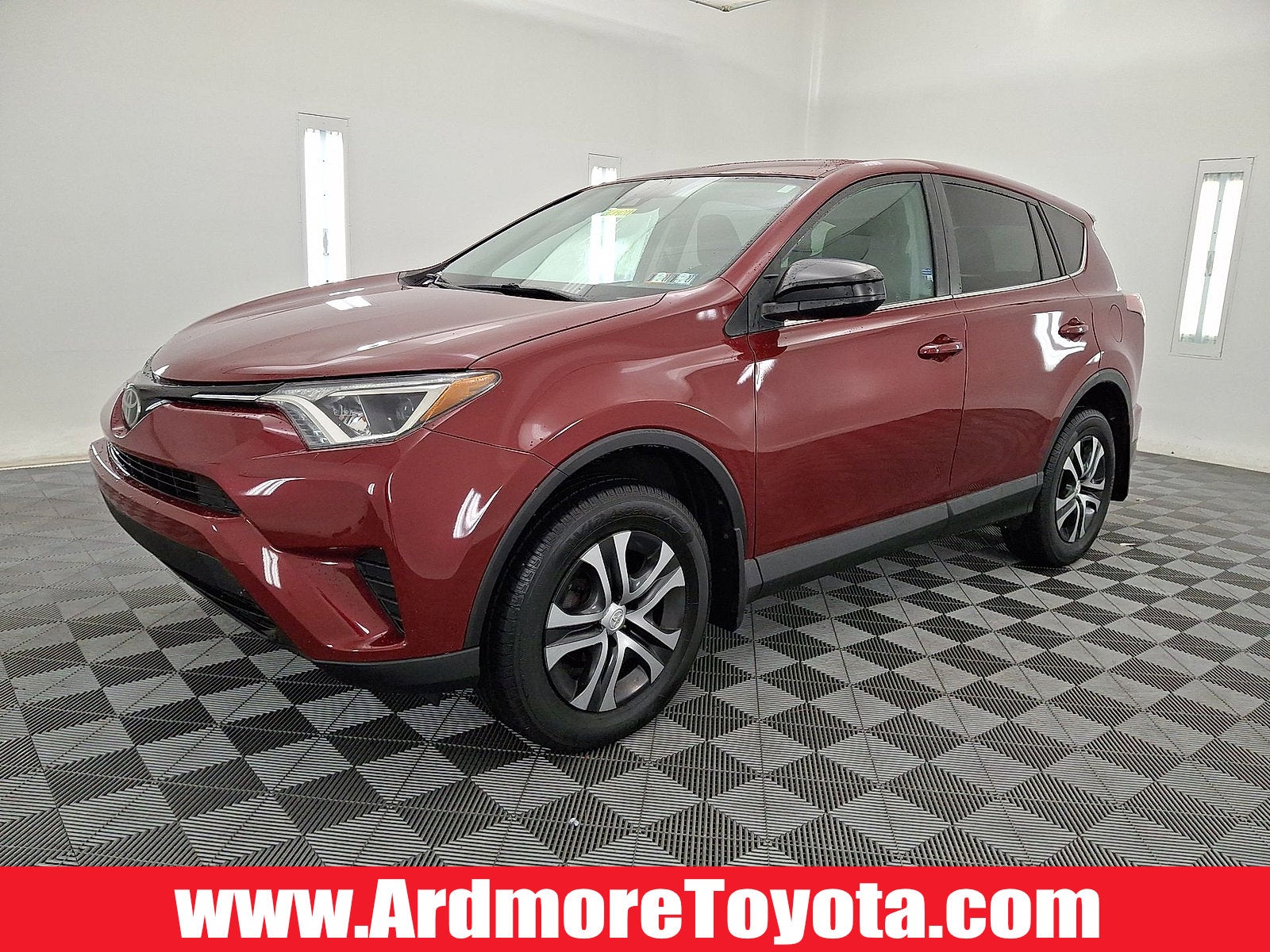 2018 Toyota RAV4 LE in Ruby Flare Pearl — front three-quarter view