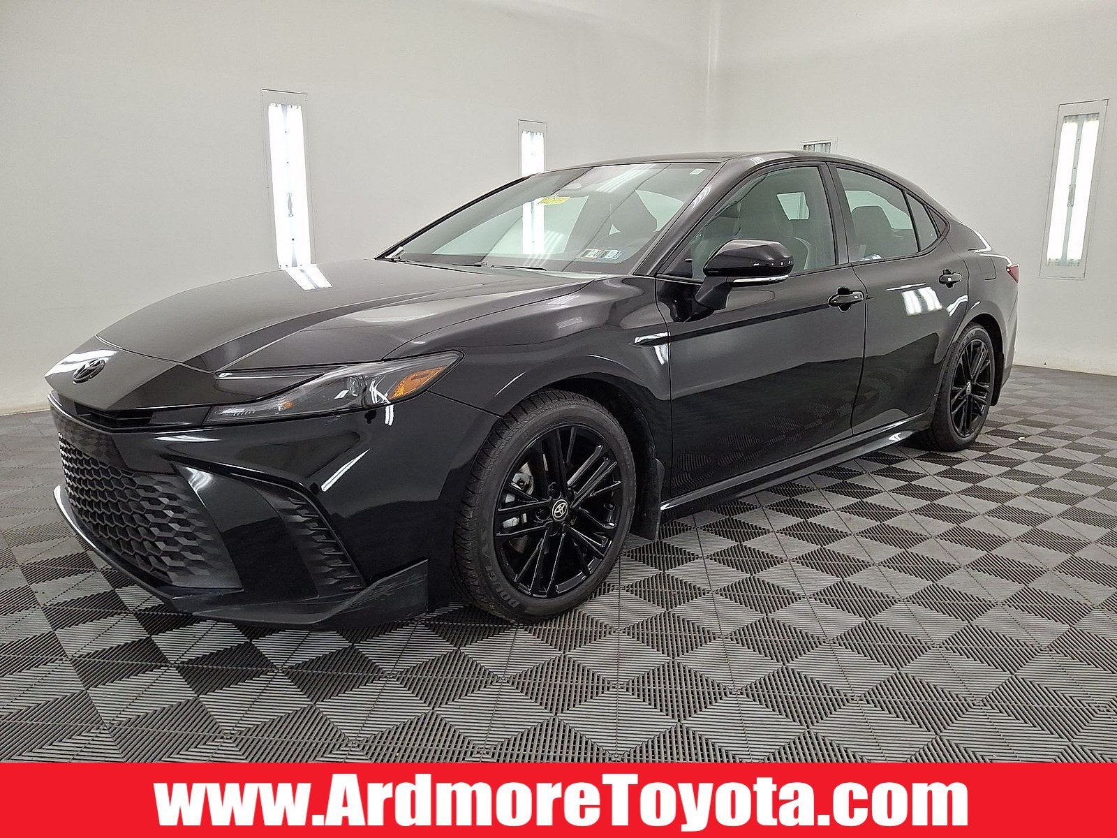 2025 Toyota Camry SE in Midnight Black Metallic — front three-quarter view