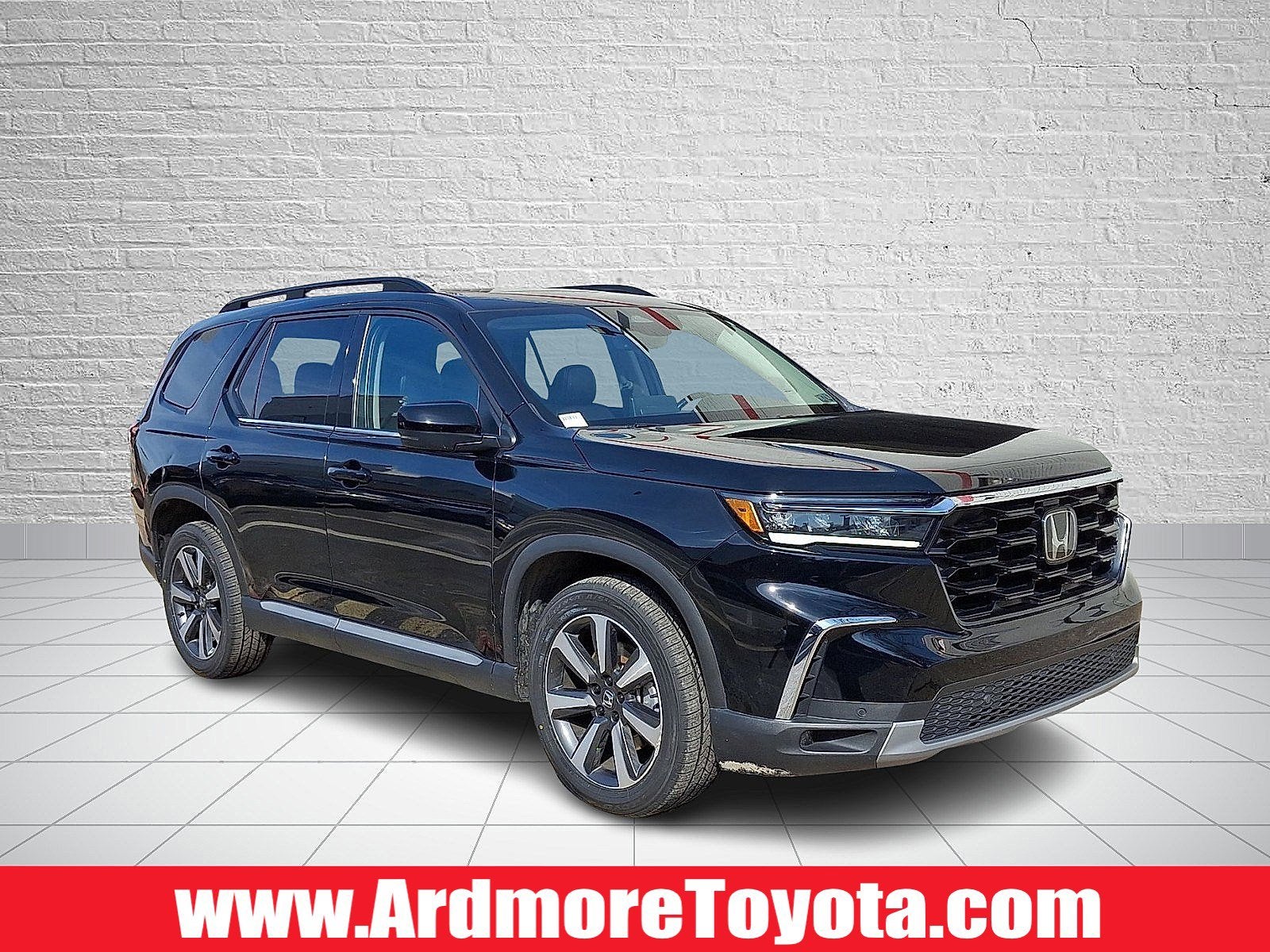 2023 Honda Pilot Touring in Crystal Black Pearl — front three-quarter view