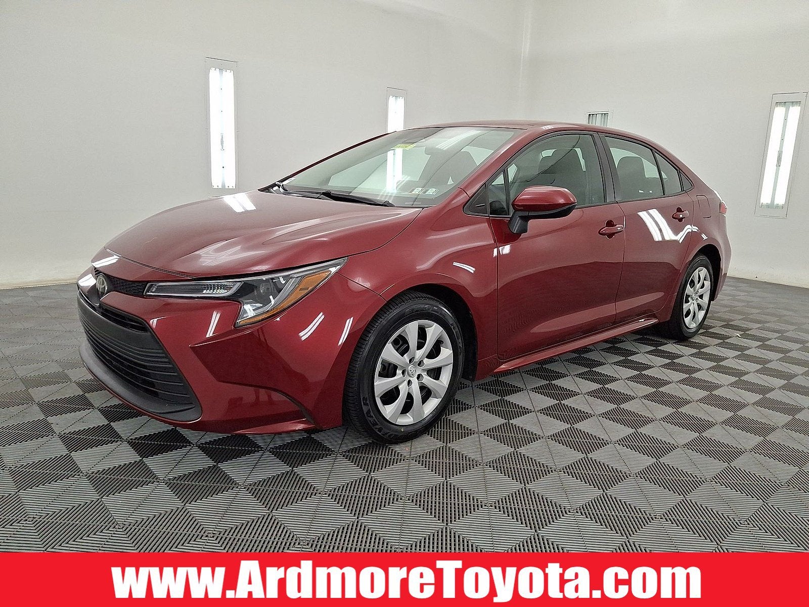 2024 Toyota Corolla LE in Ruby Flare Pearl — front three-quarter view