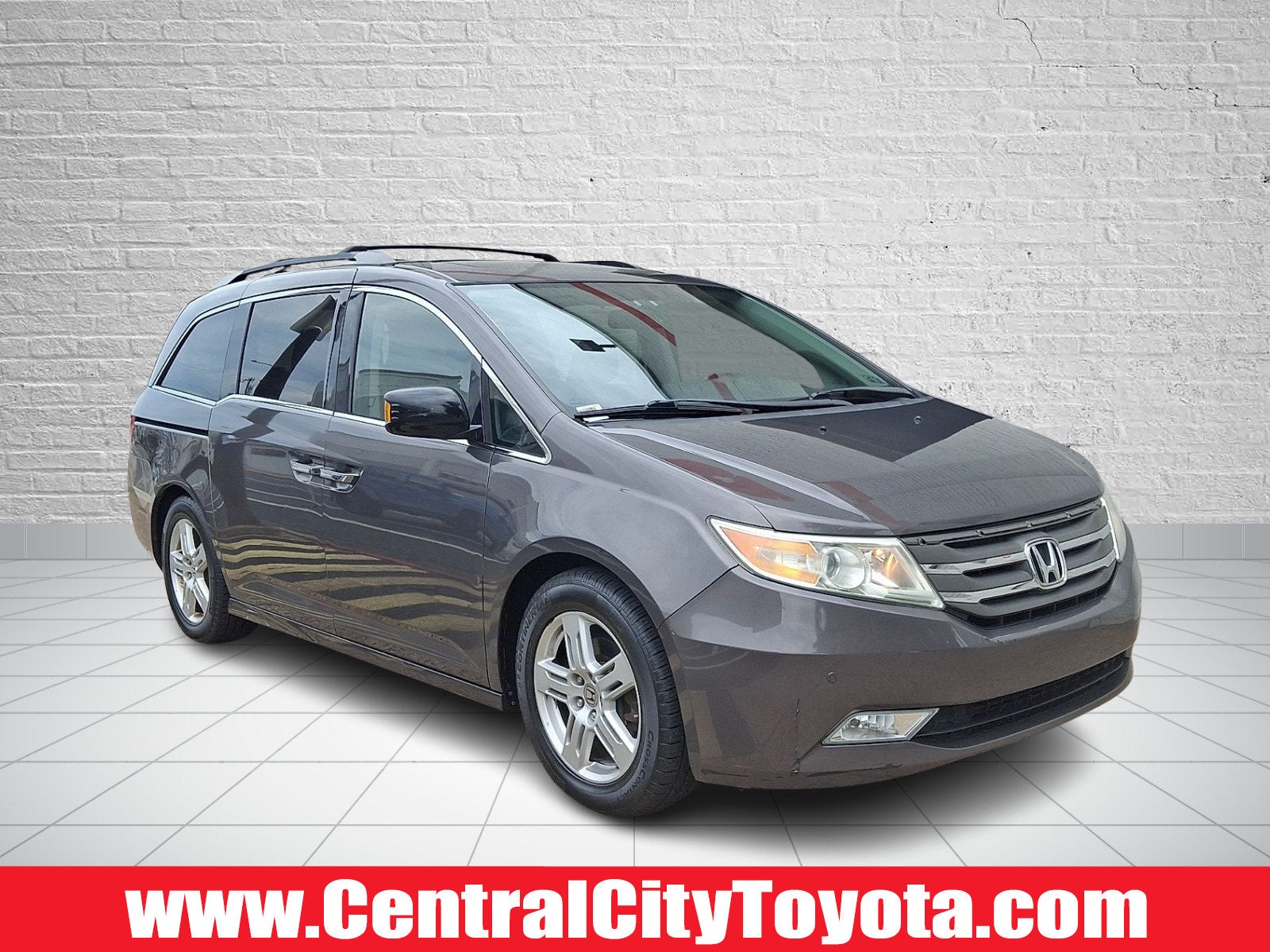 2013 Honda Odyssey Touring in Alabaster Silver Metallic — front three-quarter view